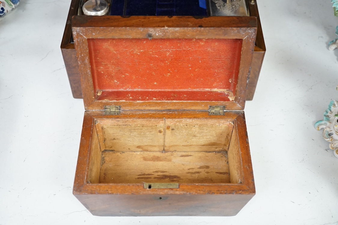 A Victorian walnut lady's toilet box with fitted interior, containing nine bottles, two glass boxes, removable sections, a hidden drawer, etc., together with two mahogany tea caddies. Condition - fair to good.